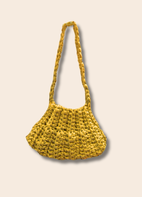 Yellow woven handbag on a beige background